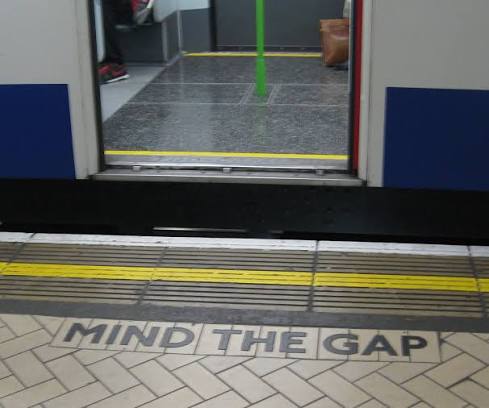 Mind the gap warning beside an open train door